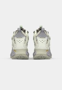 Rear view of hiking shoes featuring a light gray upper with darker gray accents, textured mesh details, and prominent rubber outsole with lugs.