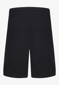 Shorts en coton noir avec une texture lisse, une taille élastique et un design simple. La vue arrière ne montre ni poches ni détails supplémentaires.