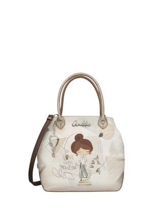 Borsa beige con manici marroni raffigurante una donna fumetto, libri e il testo "Innamorata della conoscenza" in scritta decorativa.