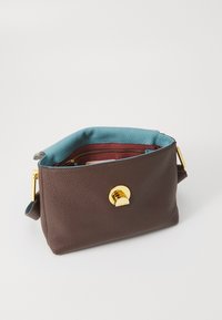 Brown textured leather handbag with a turquoise lining, gold hardware, and an adjustable strap, featuring a magnetic closure and zippered pocket.