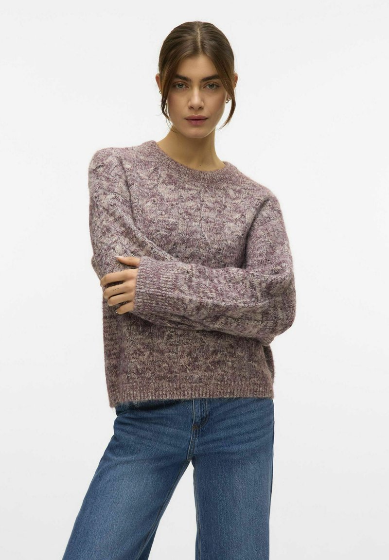 Maglione lavorato a maglia lavanda con un motivo testurizzato, scollatura rotonda e spalle cadenti, abbinato a jeans in denim blu.