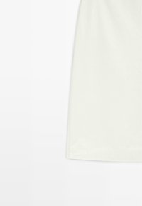 White cotton skirt featuring a smooth texture, straight cut, and clean hem. Minimalist design with no visible patterns or accents.