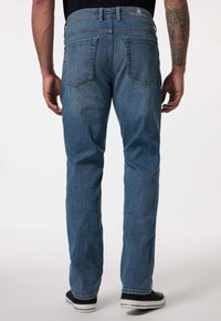 Jeans de mezclilla azul con corte recto, que cuentan con dos bolsillos traseros, costuras sutiles y una cinturilla con marca.