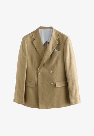 Divpusējais žakets gaiši brūnā linu audumā, ar ieapaļām klapām un divām priekšējām kabatām. Iezīmēts ar pogu detaļām un kontrastējošu iekšējo oderi.