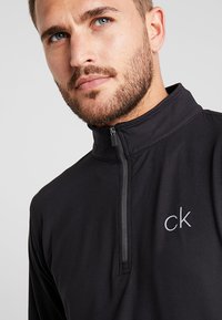 Calvin Klein Golf NEWPORT HALF ZIP - Ilgarankovis viršutinės dalies drabužis - black