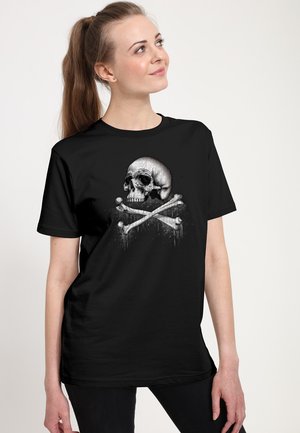 Black T-shirt made of cotton, featuring a prominent skull graphic with crossed bones in gray and white, set against a textured background.