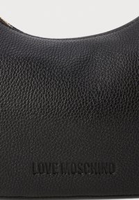 Black textured leather pouch with a rounded top, featuring embossed brand name "LOVE MOSCHINO" at the bottom. Zippered closure.