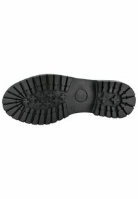 Suela de zapato de goma negra con profundas estrías y patrones cruzados para tracción; área central lisa y tacón redondeado para estabilidad.