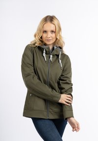 Giacca a zip verde oliva con cappuccio, coulisse e accenti grigi. Realizzata in materiale morbido; presenta bottoni laterali e una vestibilità aderente.