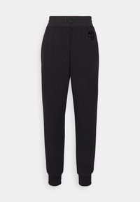 Svarta sweatpants med elastiskt midjeband och dragsko. Har ribbade muddar och en cirkulär logotyp på vänster lår. Slät textur.