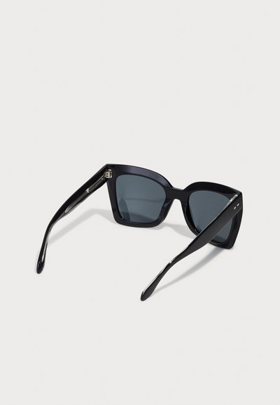 Black sunglasses with a thick, angular frame, dark lenses, and sleek, straight arms. Metal accents on the hinges add detail.