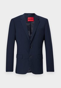 Marineblazer van gladde stof, met een tweeknopssluiting, notch-revers en twee voorkruiden. Rode merklabel aan de binnenkant.