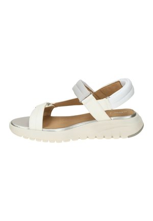 White open-toe sandal with adjustable straps, cushioned ankle support, and a thick, textured sole for added comfort and grip.