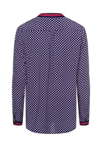 Camicia a maniche lunghe di colore blu navy con pois bianchi. Presenta un colletto a coste con dettagli rossi. Vestibilità rilassata e dettaglio con piega centrale sul retro.