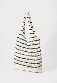 Knit tote bag featuring a white and black striped pattern, with a soft texture, spacious design, and two long handles for carrying.