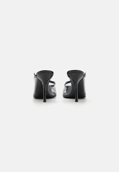 Black high-heeled sandals with transparent paneling, a pointed toe, and sleek stiletto heel. Smooth patent finish with minimalistic design.