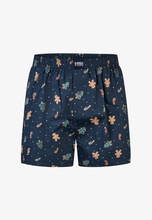 Shorts boxers bleu marine avec une ceinture élastique, ornés d'un motif de bonshommes en pain d'épice, de sapins de Noël, de cannes en sucre d'orge et de points blancs.