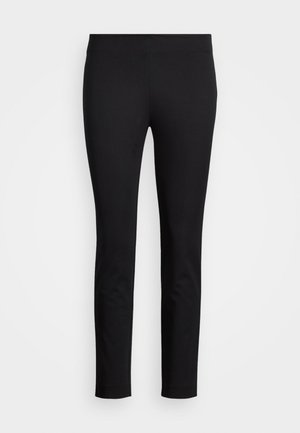 Leggings noirs en matériau extensible, avec une coupe ajustée et une texture lisse sans motifs ni accents visibles.