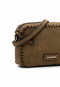 Brązowa skórzana torba crossbody z dekoracyjnym przeszyciem, z zamknięciem na zamek błyskawiczny i metalową płytką z logo. Gładka tekstura i kompaktowy design.