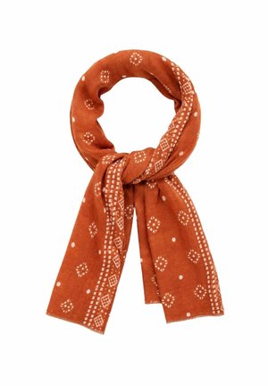 Brændt orange tørklæde med hvide geometriske og prikkede mønstre, løst bundet og vist mod en hvid baggrund.
