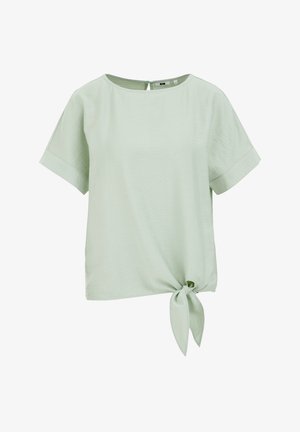 Hele roheline lühikeste varrukatega topp, ümmarguse kaelusega, esipoolse lipsu detailiga ja lõdva lõikega. Sile tekstuur ja minimaalselt nähtavad õmblused.