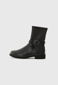 Black ankle boots with a smooth leather finish, elastic top, and a decorative strap with a silver buckle. Rectangular toe shape and flat sole.