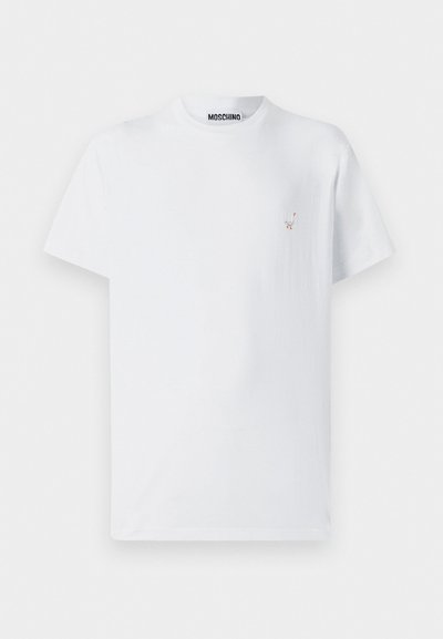 T-shirt en coton blanc avec un col rond, des manches courtes et un petit design brodé sur le côté gauche de la poitrine.