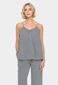Top senza maniche a righe con spalline sottili, scollo arricciato e tasche laterali. Realizzato in tessuto leggero con righe verticali bianche e nere.
