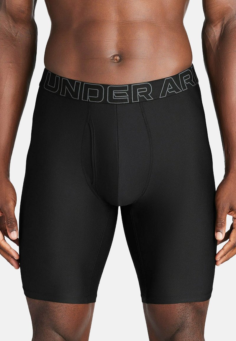 Black athletic boxer shorts with a smooth texture, featuring a logoed waistband and a fitted design that extends to mid-thigh length.