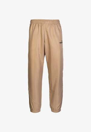 Pantaloni da corsa leggeri beige, realizzati in poliesteri lisci, con vita elasticizzata e caviglie strette, caratterizzati da un piccolo logo sul lato.
