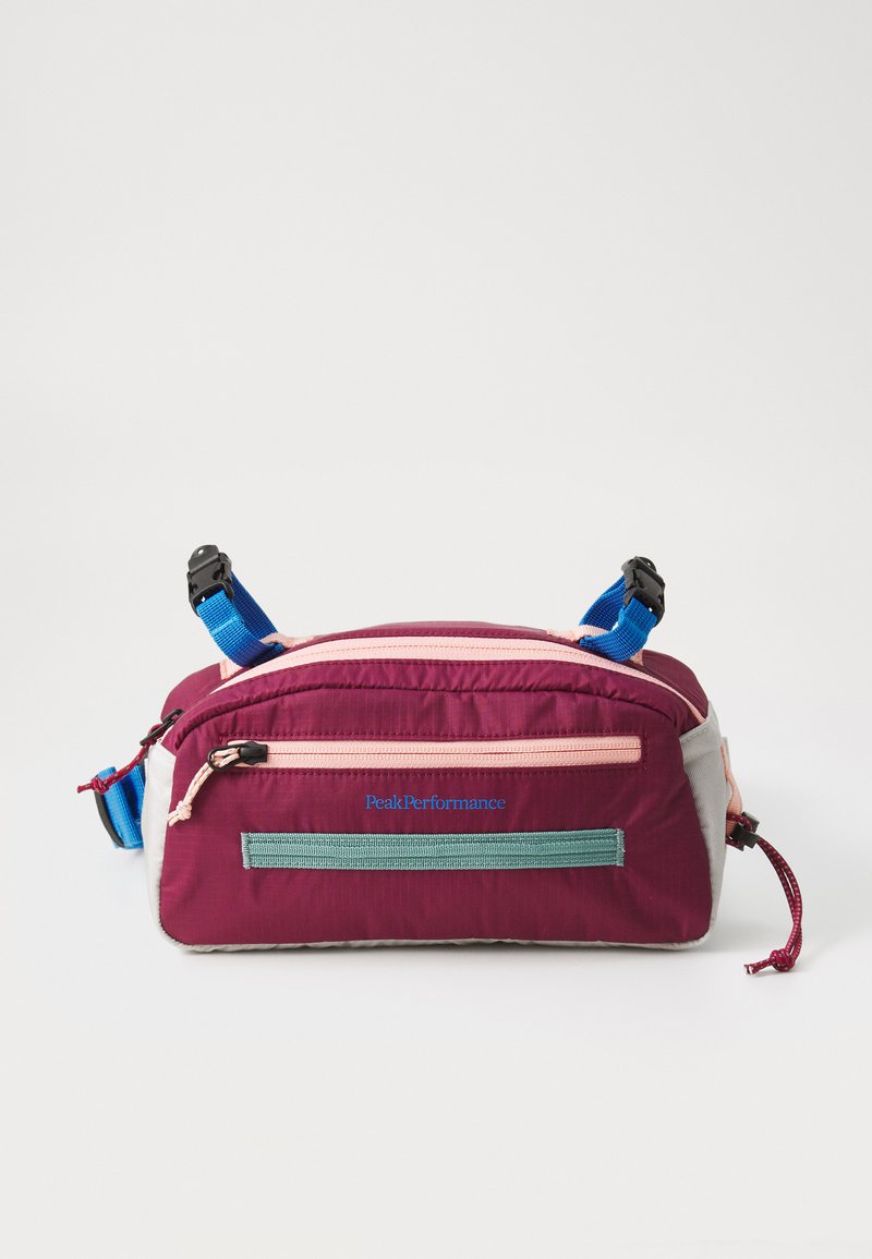 Maroon and gray fabric bag with blue and pink accents. Features top zipper, front pocket, adjustable straps, and "PeakPerformance" logo.