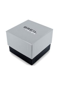 Boîte d'emballage grise et noire de forme carrée, avec une texture lisse et le texte "BREIL TRIBE" en lettres noires en gras sur le couvercle.