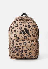 Leopard print backpack with a tan base, black accents, zip closure, and a front pocket. Features a top handle and padded shoulder straps.
