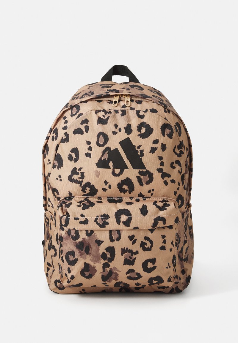 Leopard print backpack with a tan base, black accents, zip closure, and a front pocket. Features a top handle and padded shoulder straps.