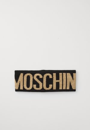 Bandeau tricoté noir portant le nom de la marque "MOSCHIN" en lettres dorées en gras. Le matériau a une texture lisse.