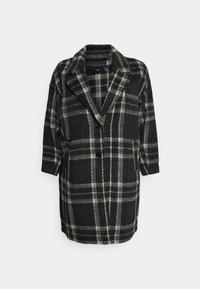 Geruite jas in donker groen, grijs en wit. Wolmix stof, oversized ontwerp, brede revers, twee voorzakken en een sluiting met één knoop.