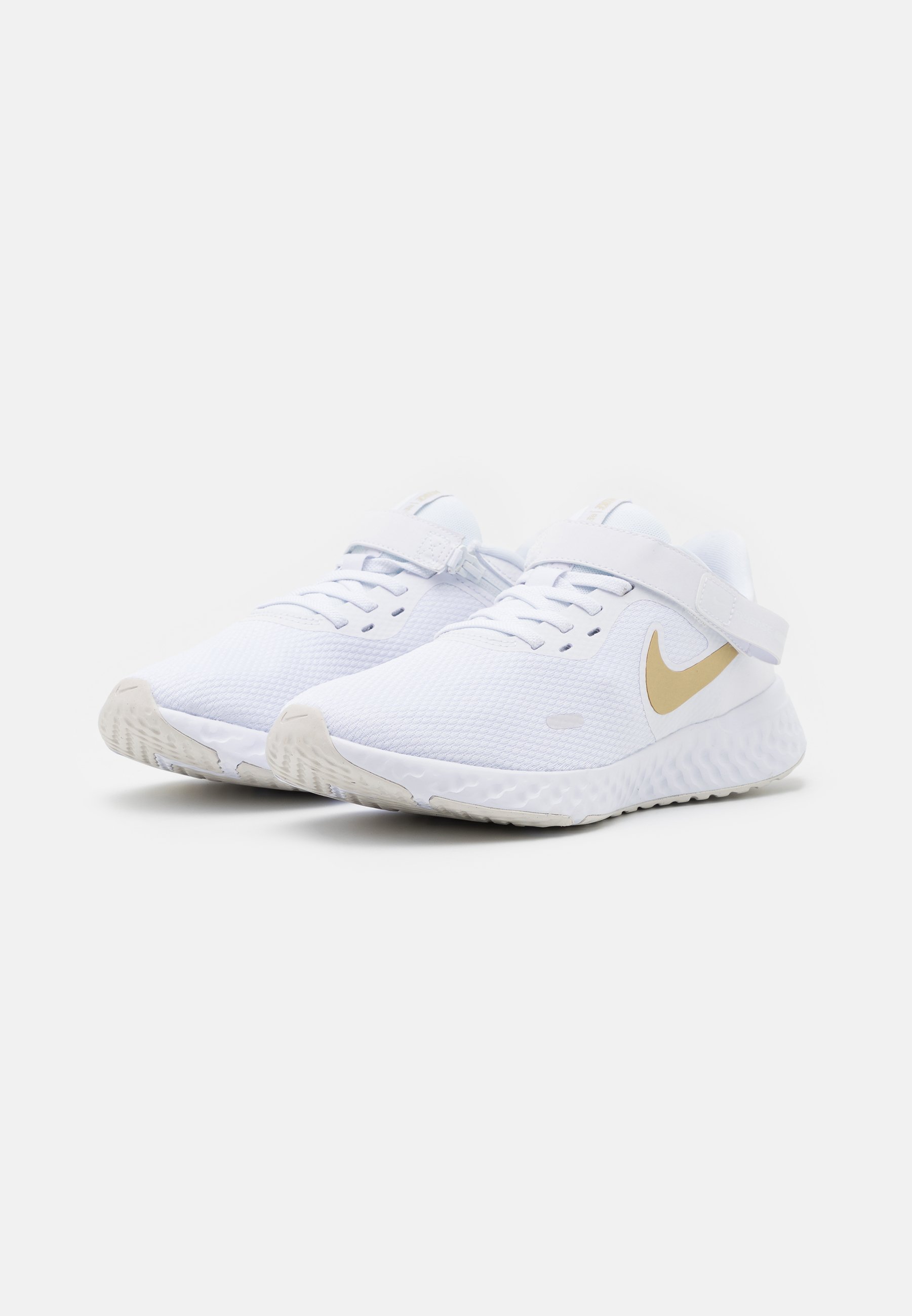 white and gold running shoes