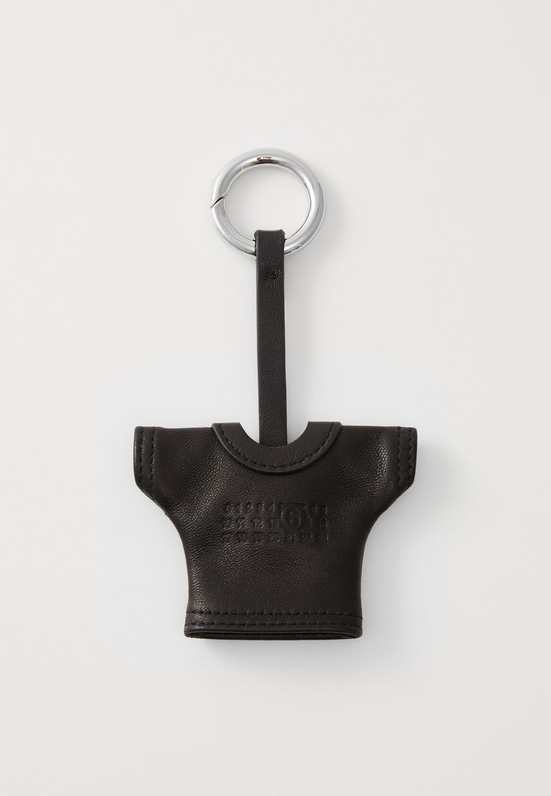 Black leather keychain in the shape of a T-shirt, featuring a circular silver keyring and embossed branding on the front.