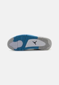 White athletic shoe sole with a blue accent and textured gray rubber. Features herringbone and circular patterns for grip. Logo visible.