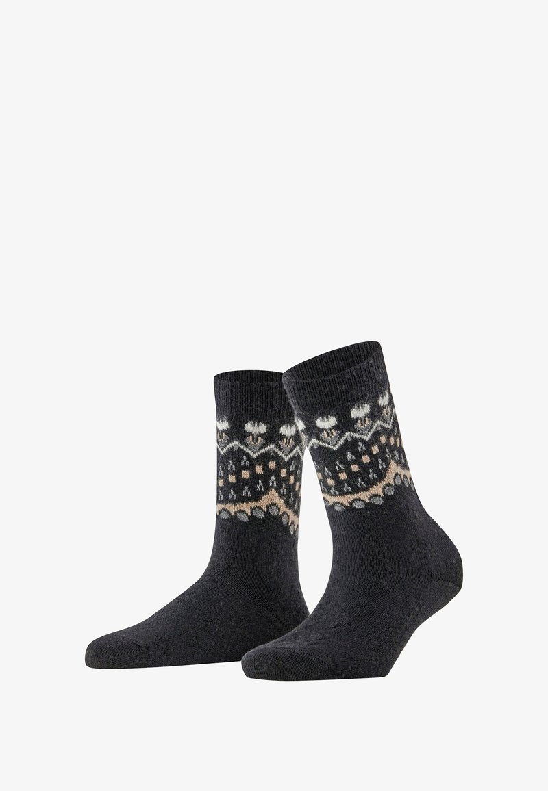 Chaussettes gris foncé avec des motifs en blanc et beige, comportant des formes géométriques et des designs de flocons de neige, fabriquées à partir d'un matériau tricoté texturé.