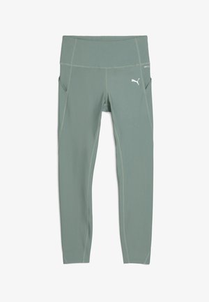 Strækbare, mellemhøje leggings i lys grøn med en glat overflade, der har sidelommer og hvide logoaccente på taljen og låret.