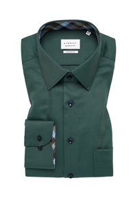 Camicia da uomo verde scuro con vestibilità su misura, caratterizzata da una texture a doppio passo, bottoni neri e un motivo a quadri contrastante all'interno del colletto e dei polsini.