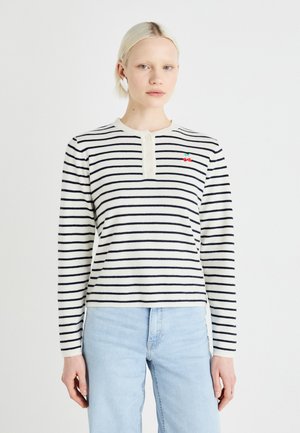 Striped long-sleeve shirt in cream with navy stripes, featuring a buttoned henley neckline and small embroidered cherry detail on the chest.