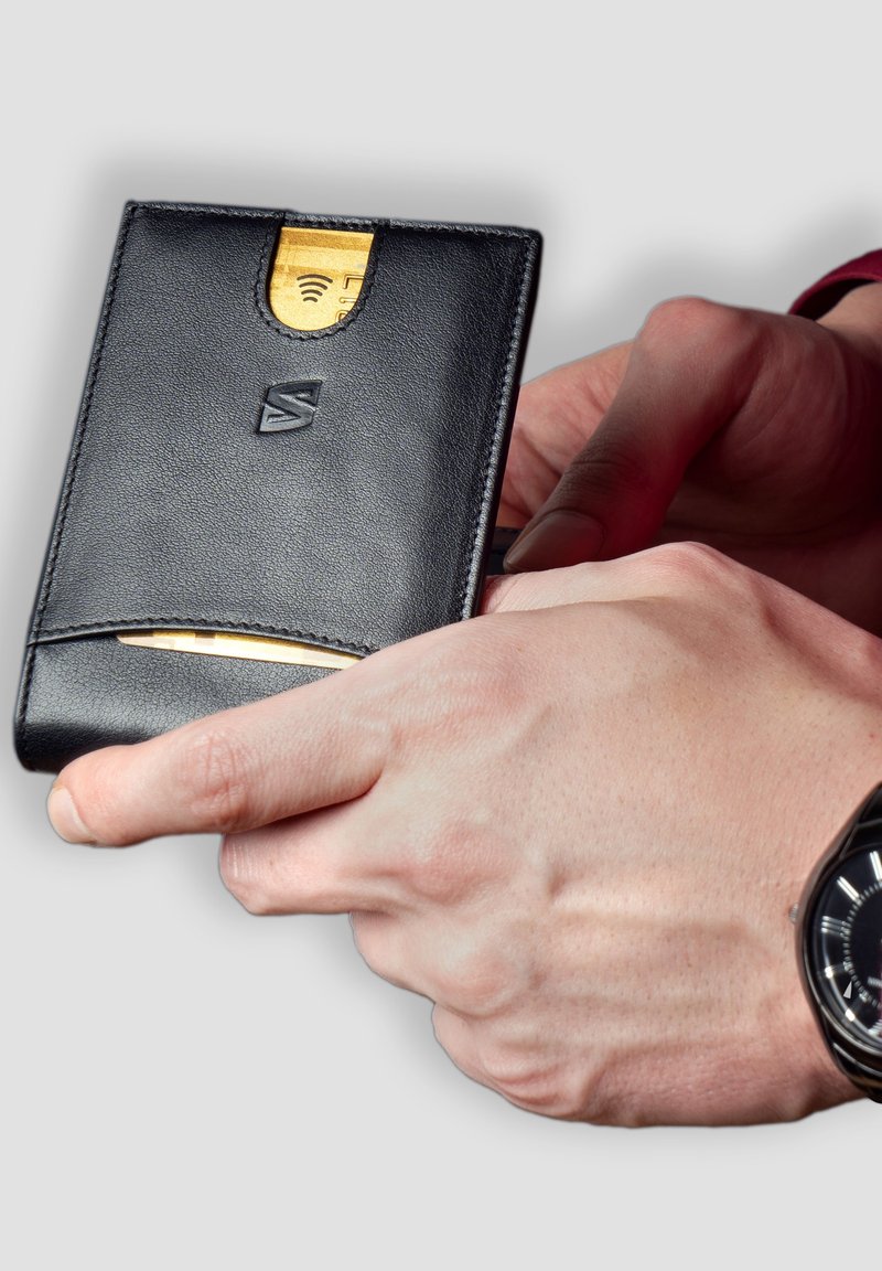 Black leather wallet featuring a textured surface, card slot, and a gold card visibly partially inserted. Simple design with a logo.