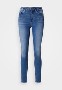 Úzké džíny vyrobené z světle modrého denim, s vysokým pasem, klasickým designem pěti kapes a surovým lemem na kotnících.