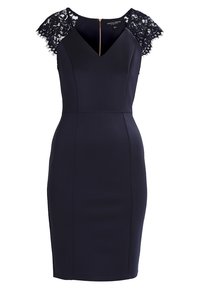 Navy blue dress with a fitted silhouette, lace short sleeves, and a V-neck. Features a back zipper and structured seams for contouring.