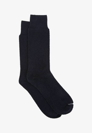 Granatowe skarpetki bawełniane o miękkim, teksturowanym wykończeniu, z prążkowanym mankietem i wyraźną sekcją na palce dla komfortowego noszenia.