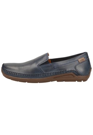 Mørkeblå læder slip-on sko med en brun sål, der har syede detaljer langs fronten og et glat, minimalistisk design.