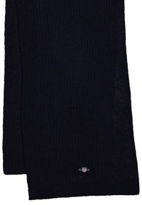 Sciarpa a coste in navy realizzata in tessuto morbido, con un sottile accento del logo vicino al fondo. Forma lunga e rettangolare per avvolgere.