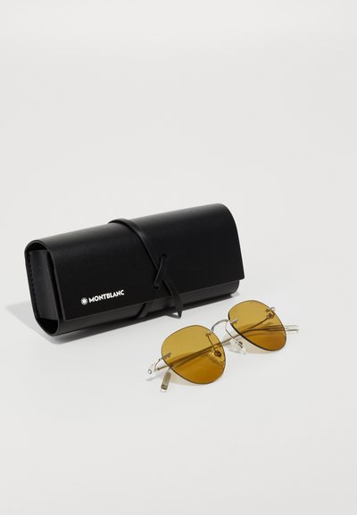 Ochelari de soare Montblanc cu lentile amber-tinted, rame din metal argintiu și accente clare. Include un toc din piele neagră cu închidere prin legare.